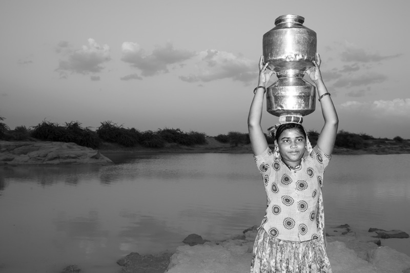 Human Right to Water in Kutch district, Gujarat - A young girl fetching water alone from a distant pond at dusk